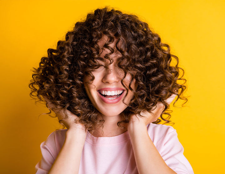 Happy woman smiling with curly hair