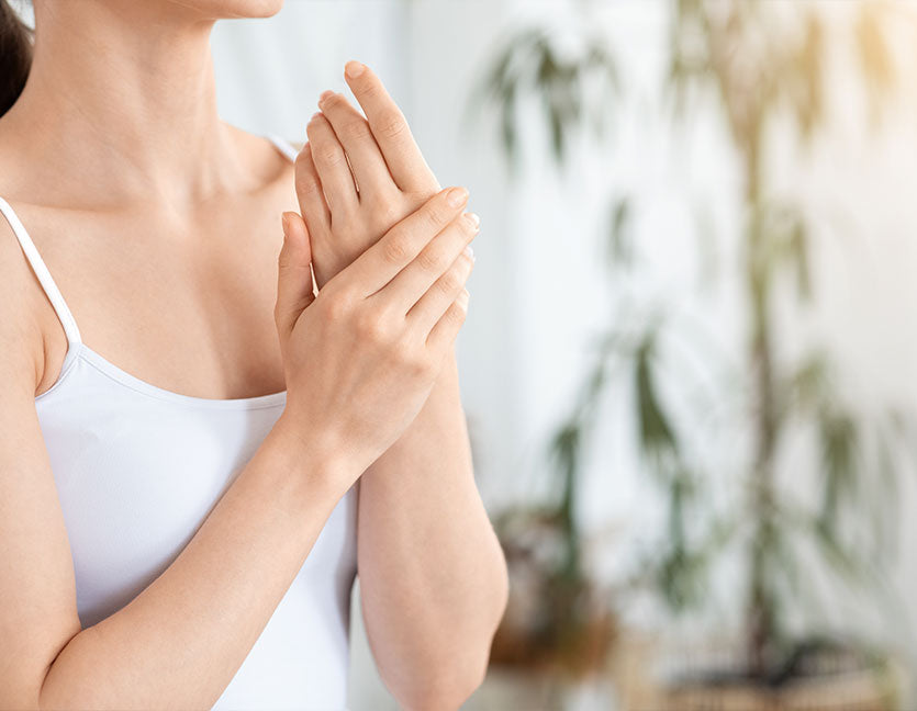 woman putting on CBD pain relief cream on her hands